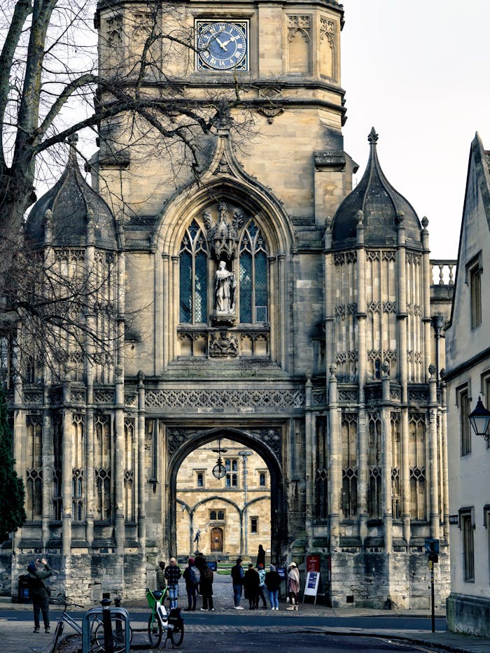 The iconic entrance gate of Magdalen College, Oxford, England, featuring stunning gothic architecture.