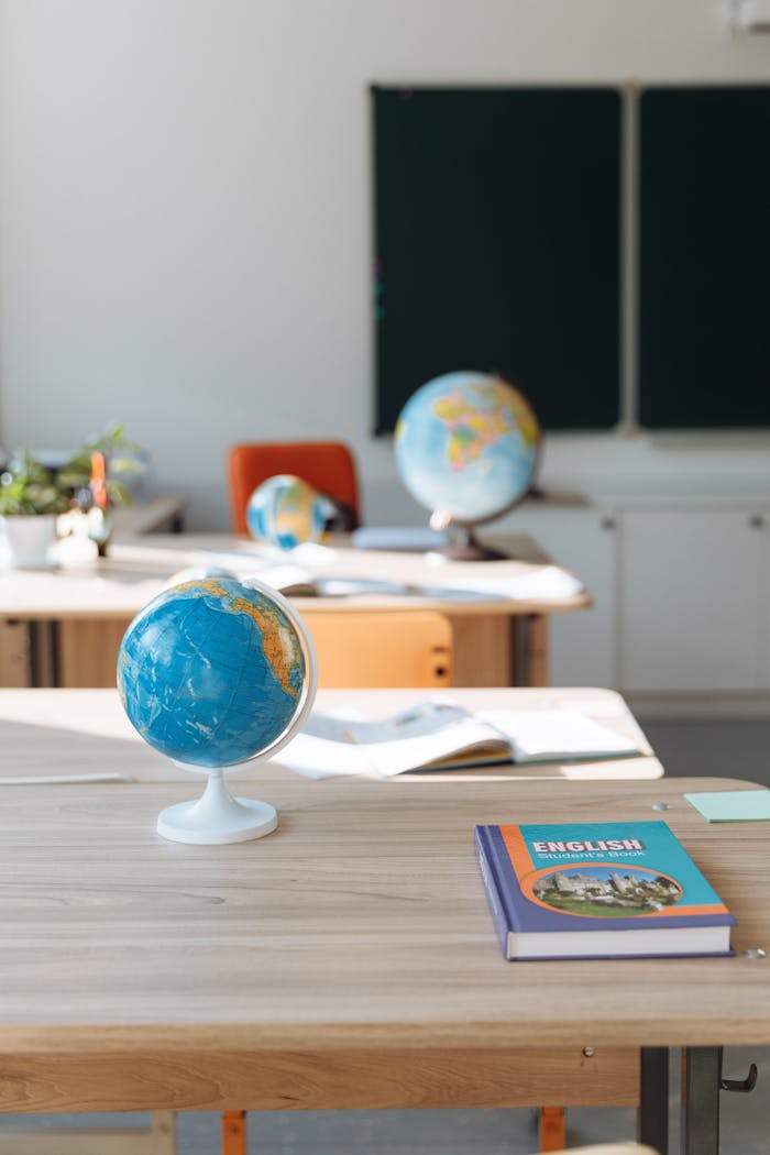 services-03 Classroom interior featuring globes, English book, and desks in sunlight